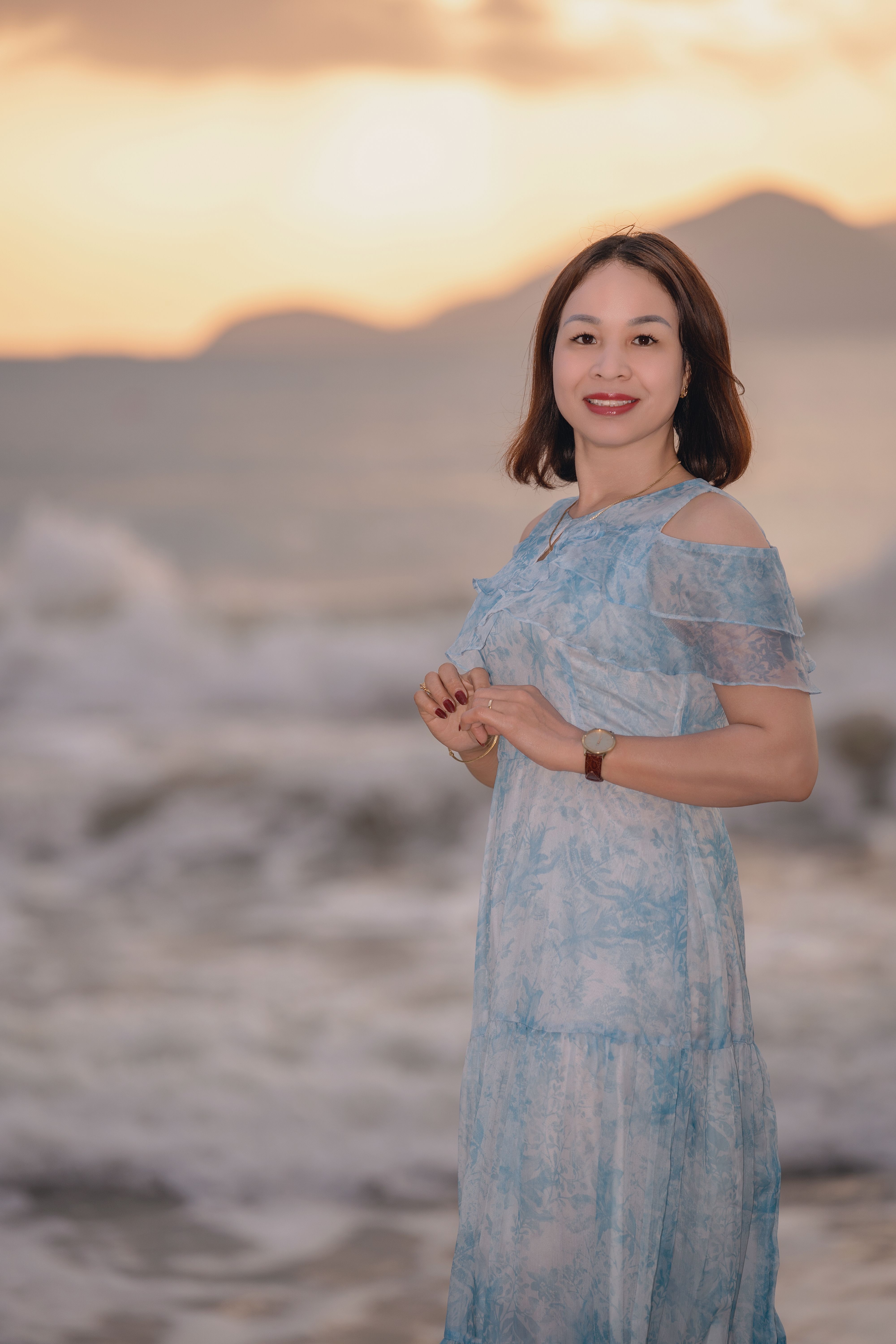 Woman Posing by the Ocean at Sunset · Free Stock Photo