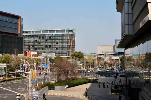 A bustling urban scene featuring modern office buildings and a busy street.