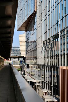 Dynamic perspective of a contemporary glass and steel building facade.