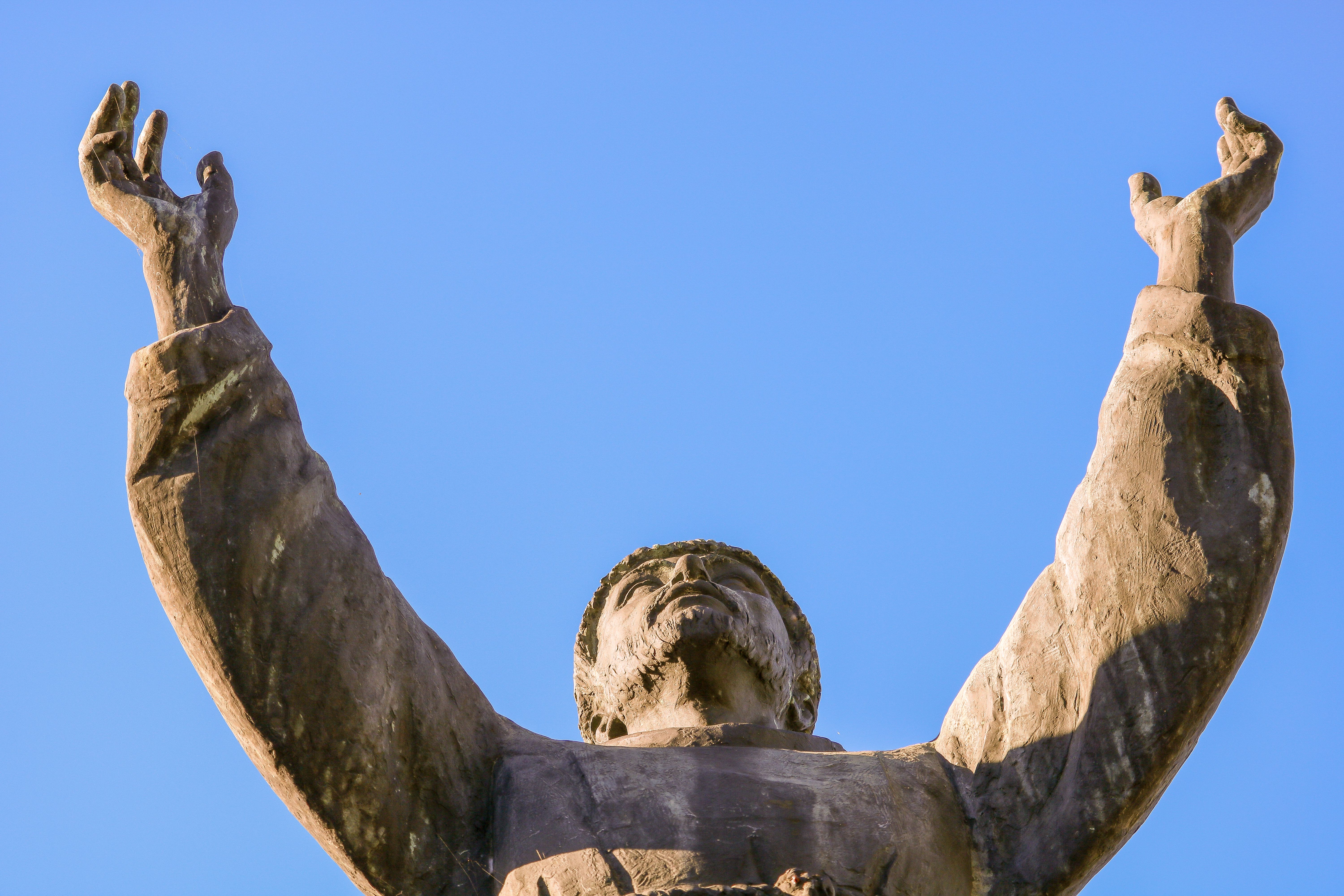 Majestic Statue Reaching Towards Clear Blue Sky · Free Stock Photo