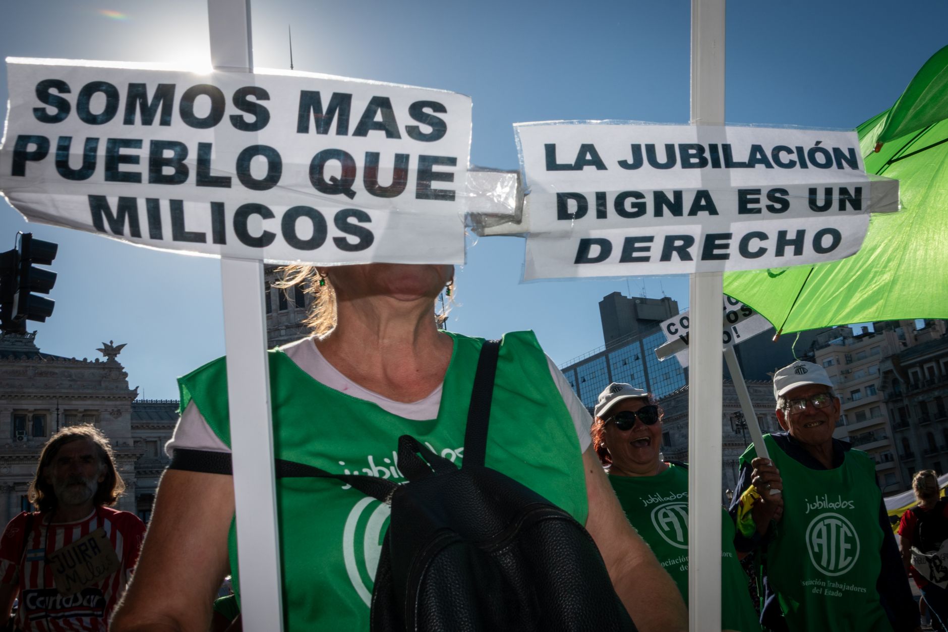 Street protest in Buenos Aires advocating for pension rights with visible signs and demonstrators.