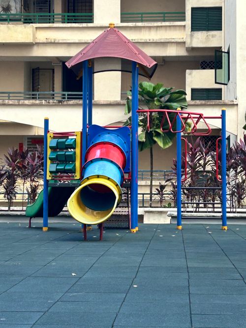 Free Vibrant playground with slide and climbing area in urban residential courtyard. Stock Photo