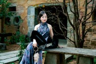 Elegant Woman in Historical Courtyard Setting