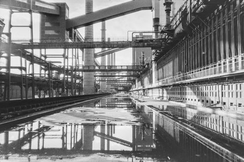 Free Monochrome view of an industrial facility with reflections in a calm pool. Stock Photo