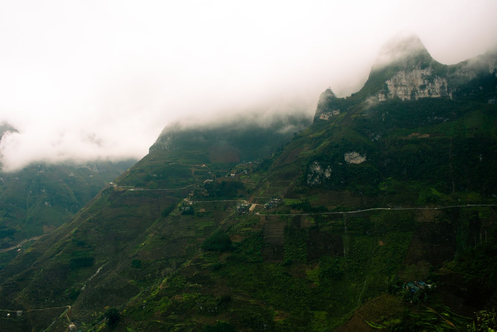 Misty mountain landscape in Ha Giang Vietnam with clouds and green valleys