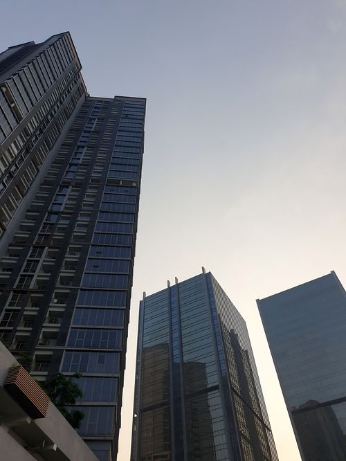 Free View of modern skyscrapers reaching towards a clear sky. Stock Photo