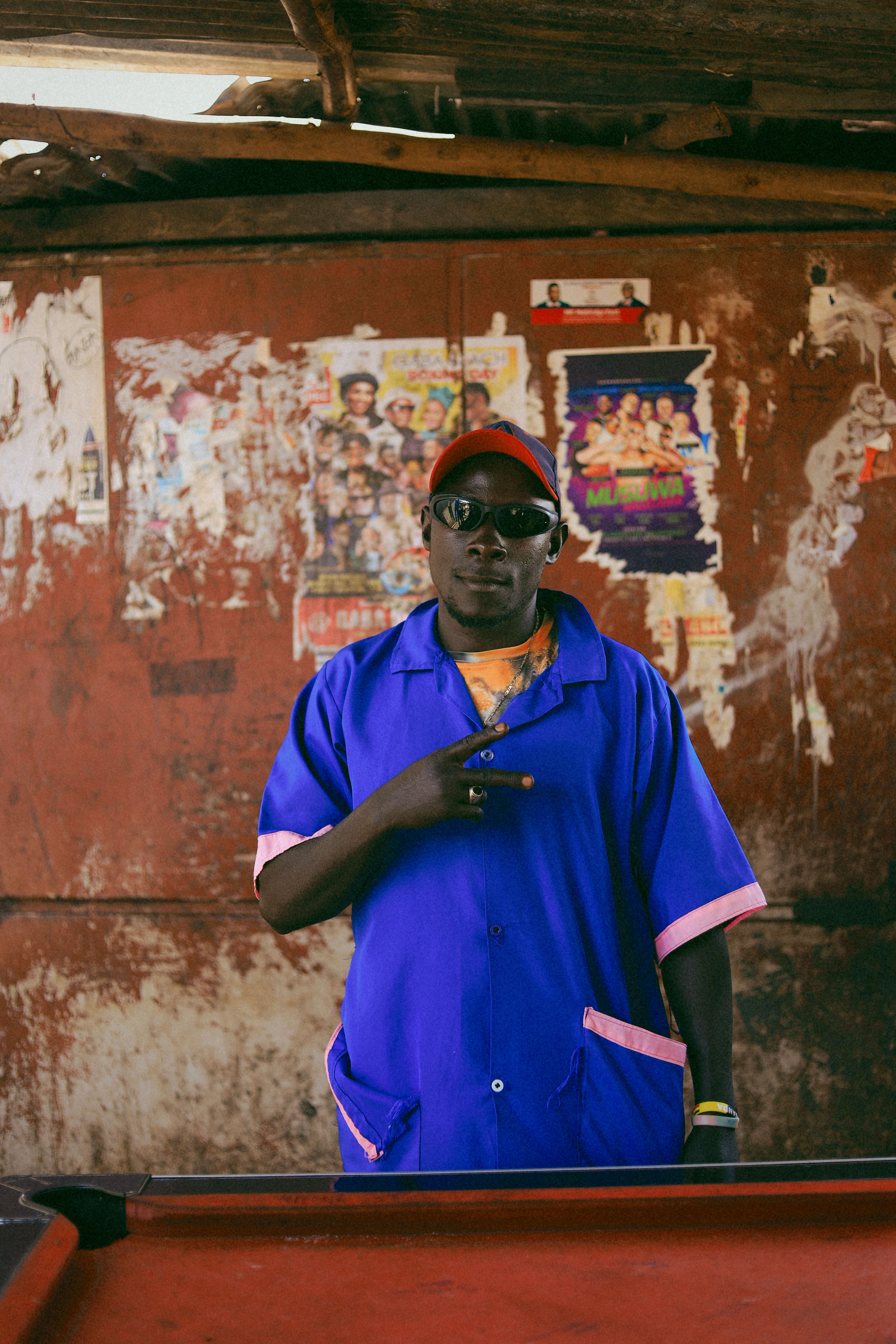 Man posing in vibrant blue traditional outfit, Congo