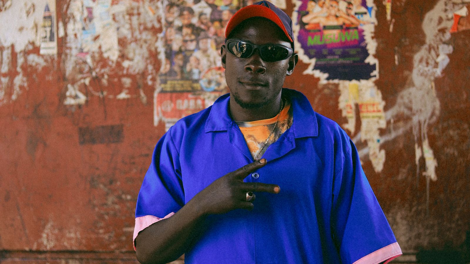 Man posing in vibrant blue traditional outfit, Congo