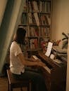 Woman Practicing Piano at Home with Sheet Music
