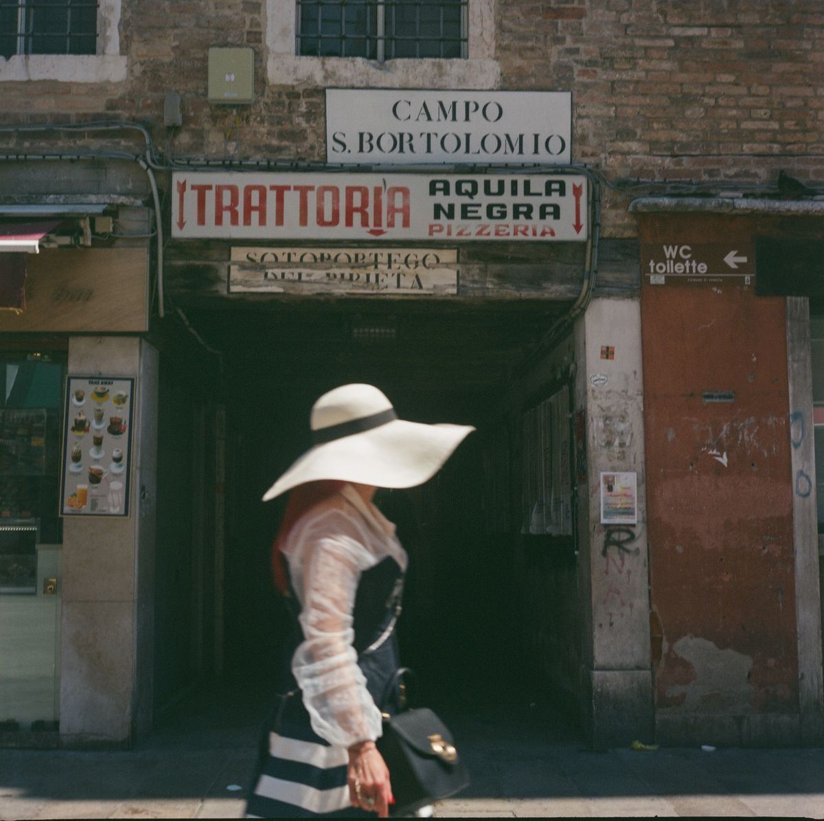 A stylish woman walking through Venice