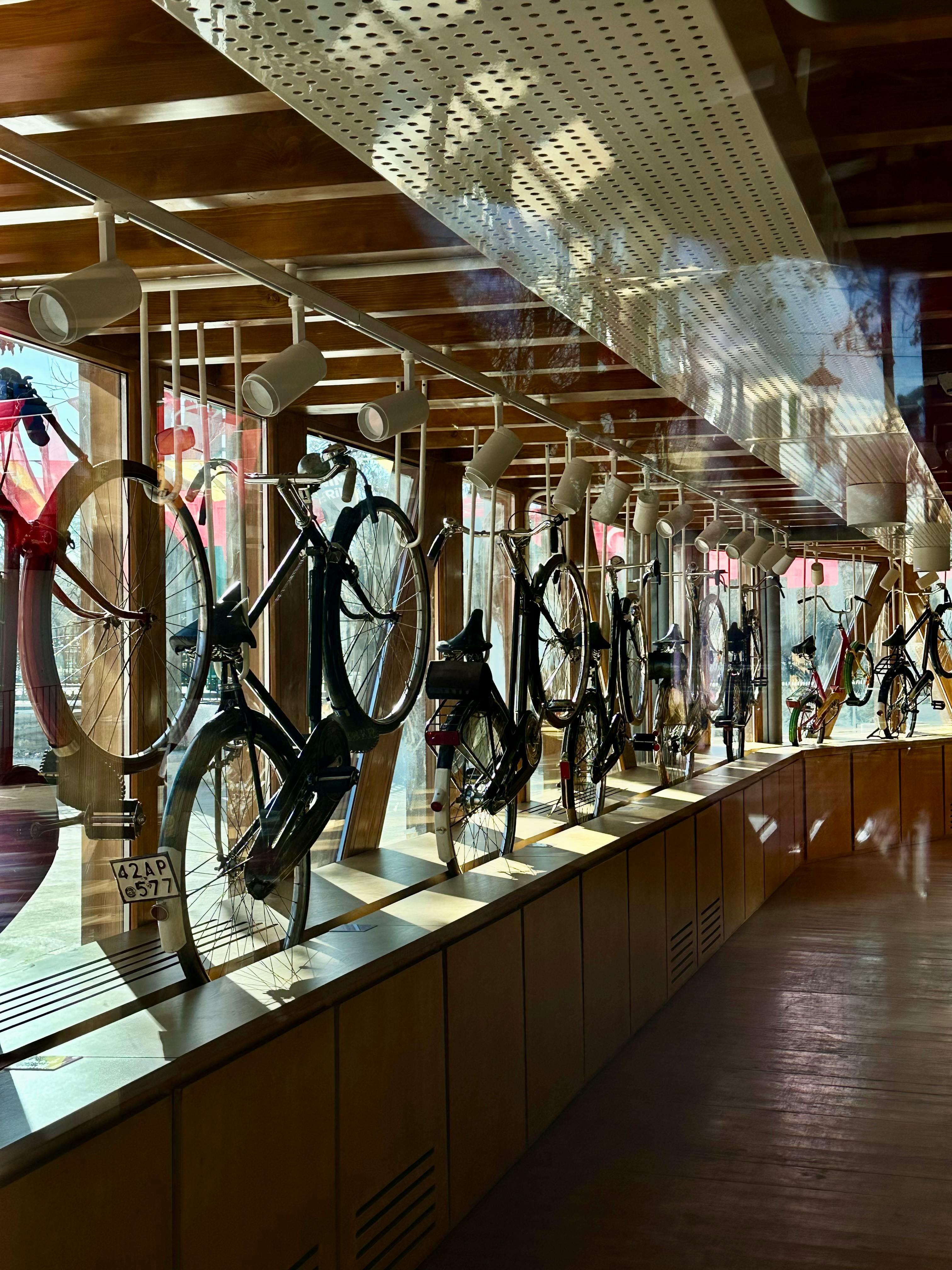 A line of vintage bicycles displayed indoors at a museum in Konya, Türkiye, showcasing historical cycling artifacts.
