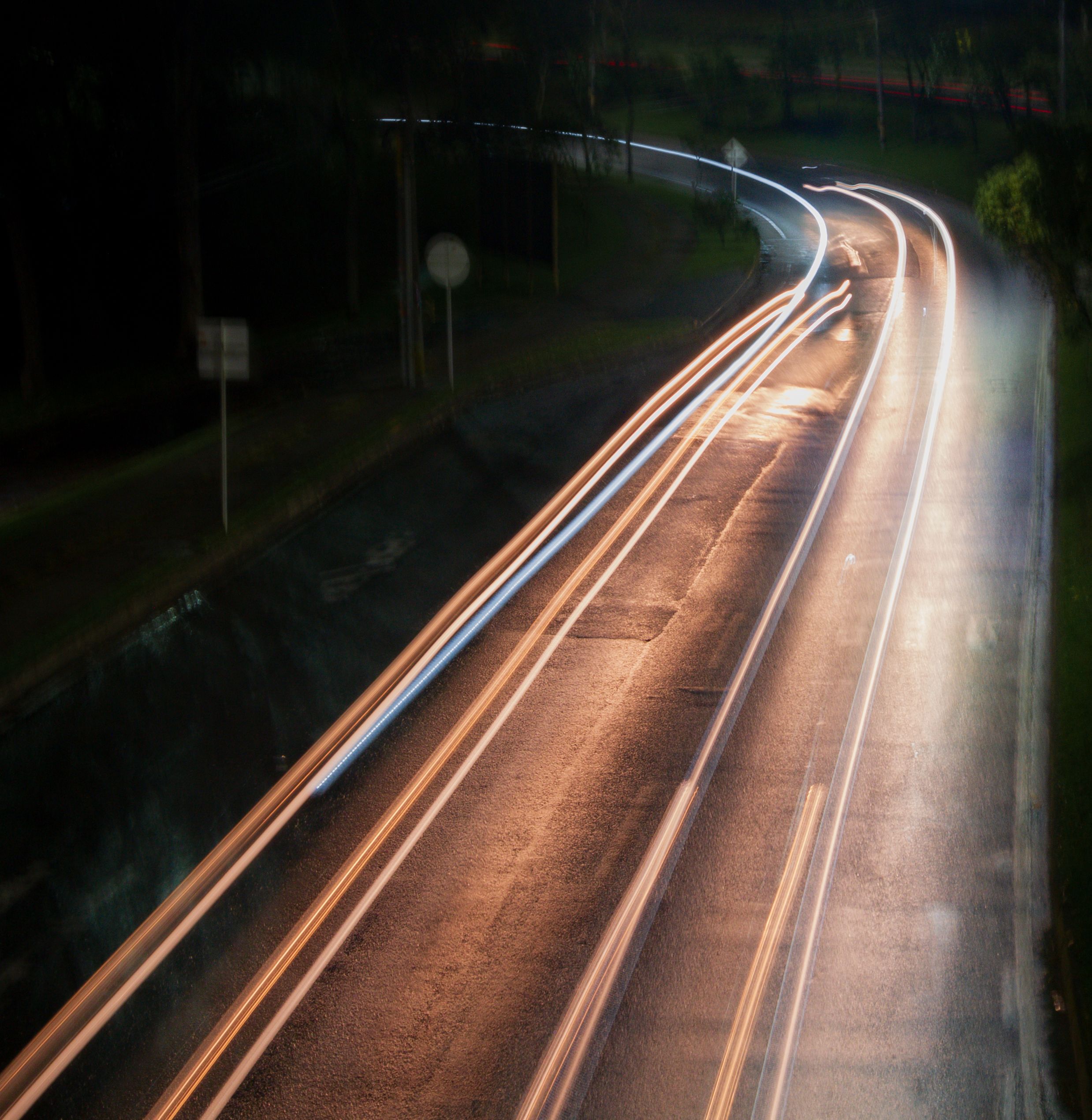 Dynamic Light Trails on Curved Road at Night · Free Stock Photo