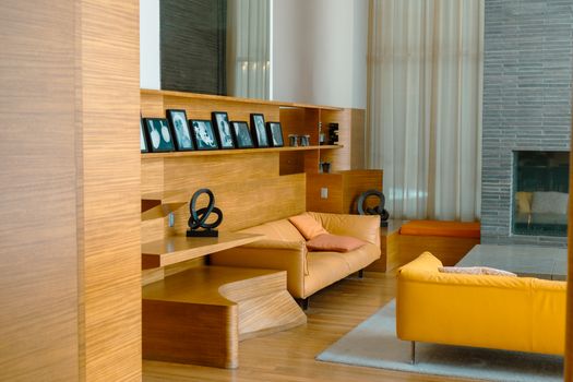 Inviting modern lounge with warm wooden accents and bright seating, in a New York apartment.