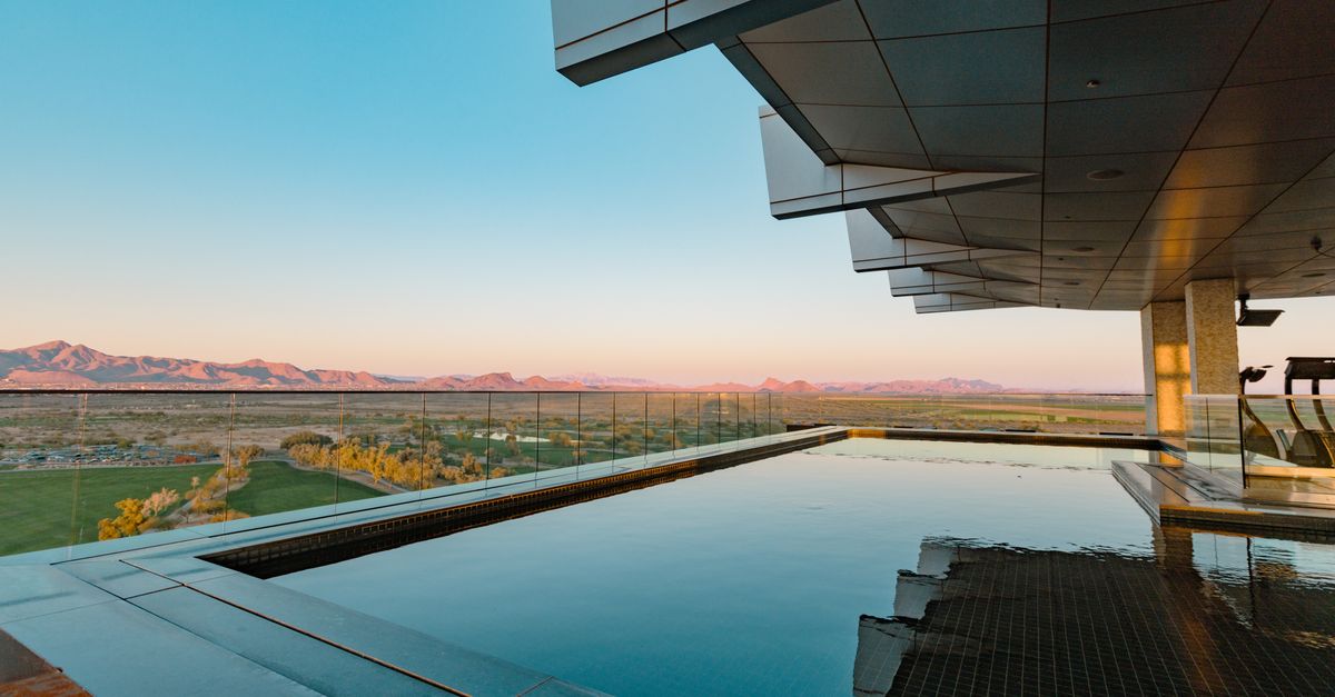 Infinity pool overlooking Arizona mountains at a modern Scottsdale hotel.