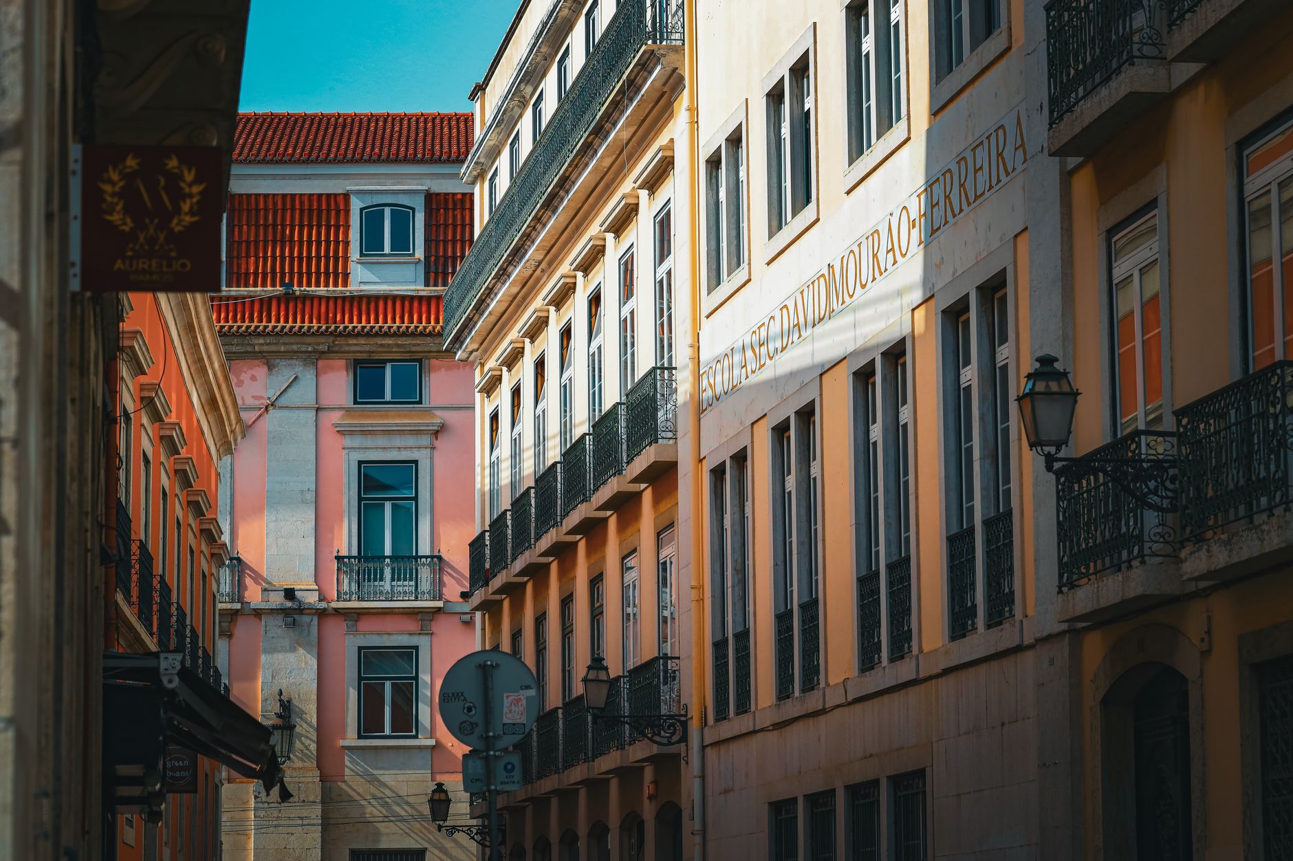 Charming street view of colorful buildings in Lisbon's architectural district under bright daylight.