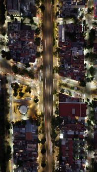 A mesmerizing aerial view of a city intersection illuminated at night.