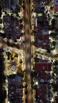 Stunning aerial view of city streets at night, showcasing vibrant urban life.