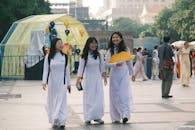 Happy women in traditional white dresses outdoors
