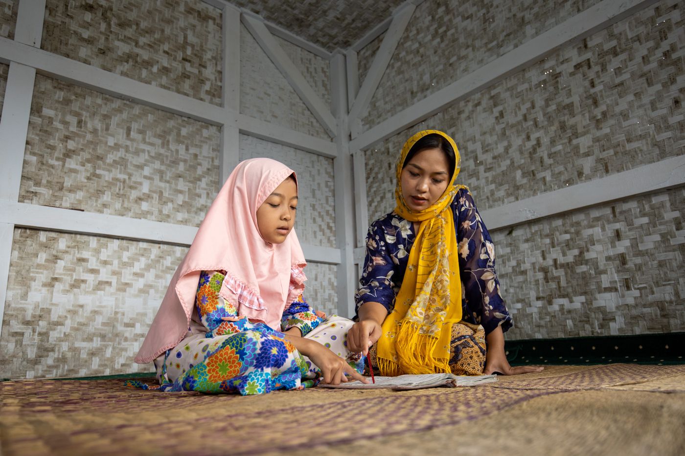 Mother and child studying the Quran together at home