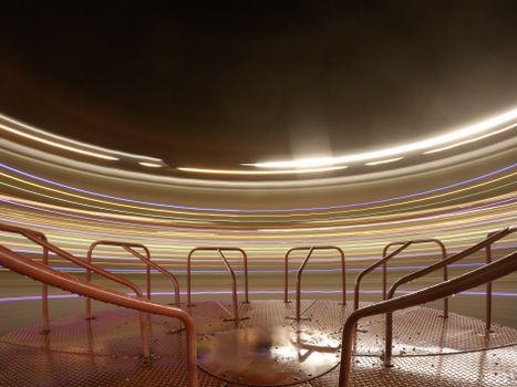 Long exposure shot of lights creating circular patterns on a playground carousel at night.