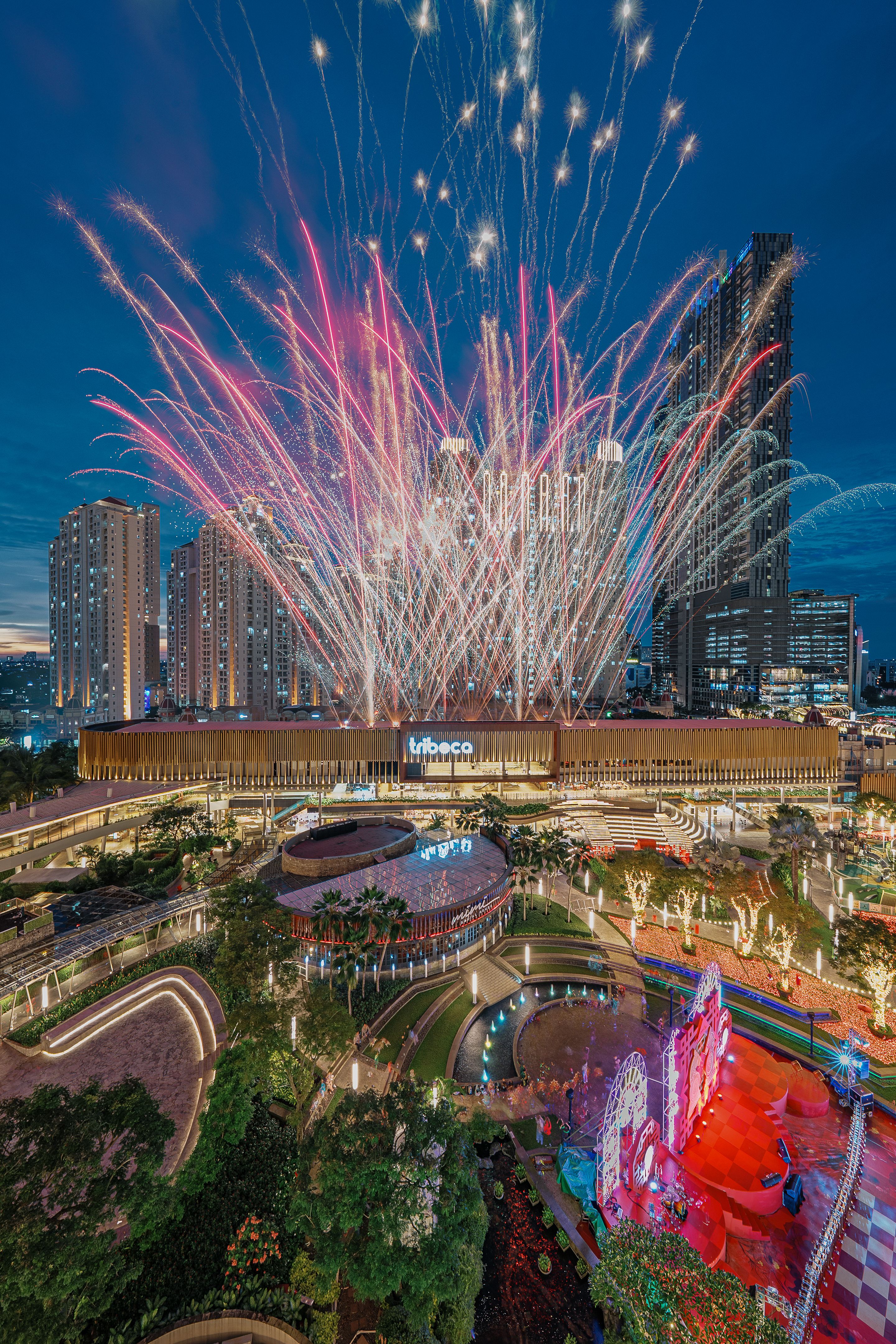 Stunning fireworks display over Tribeca Park, Jakarta, showcasing vibrant colors and cityscape.
