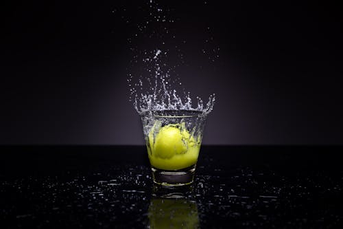 Free Clear Shot Glass With Tennis Ball Stock Photo