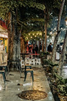 Charming Surabaya street at night, adorned with fairy lights and lively ambiance. - Fotografer Sidoarjo