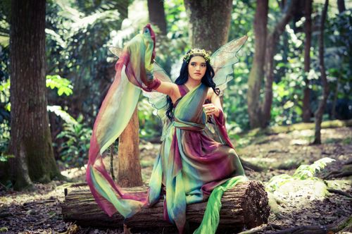 Free A mystical fairy in vibrant costume graces the lush Indonesian forest, embodying magic and fantasy. Stock Photo