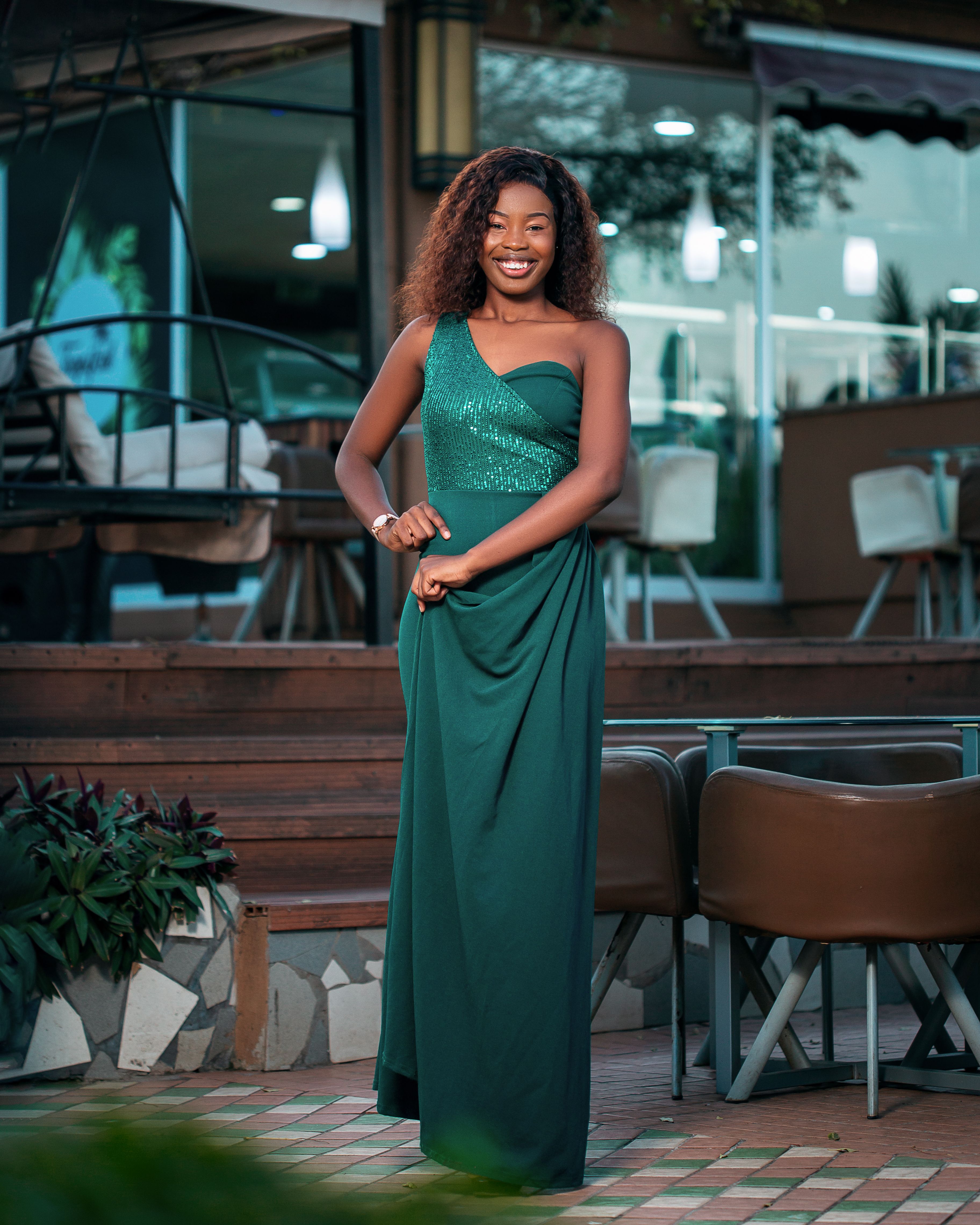 Elegant African Woman in Green Dress at Outdoor Cafe · Free Stock Photo