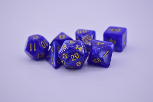 Close-up of purple polyhedral dice on a white surface, perfect for tabletop gaming enthusiasts.