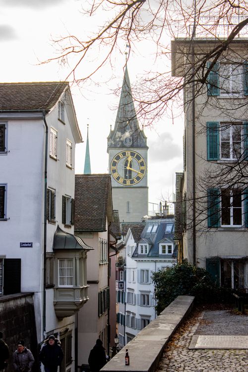 Free Street view showcasing St. Peter Church's iconic clock tower in Zurich, Switzerland. Stock Photo