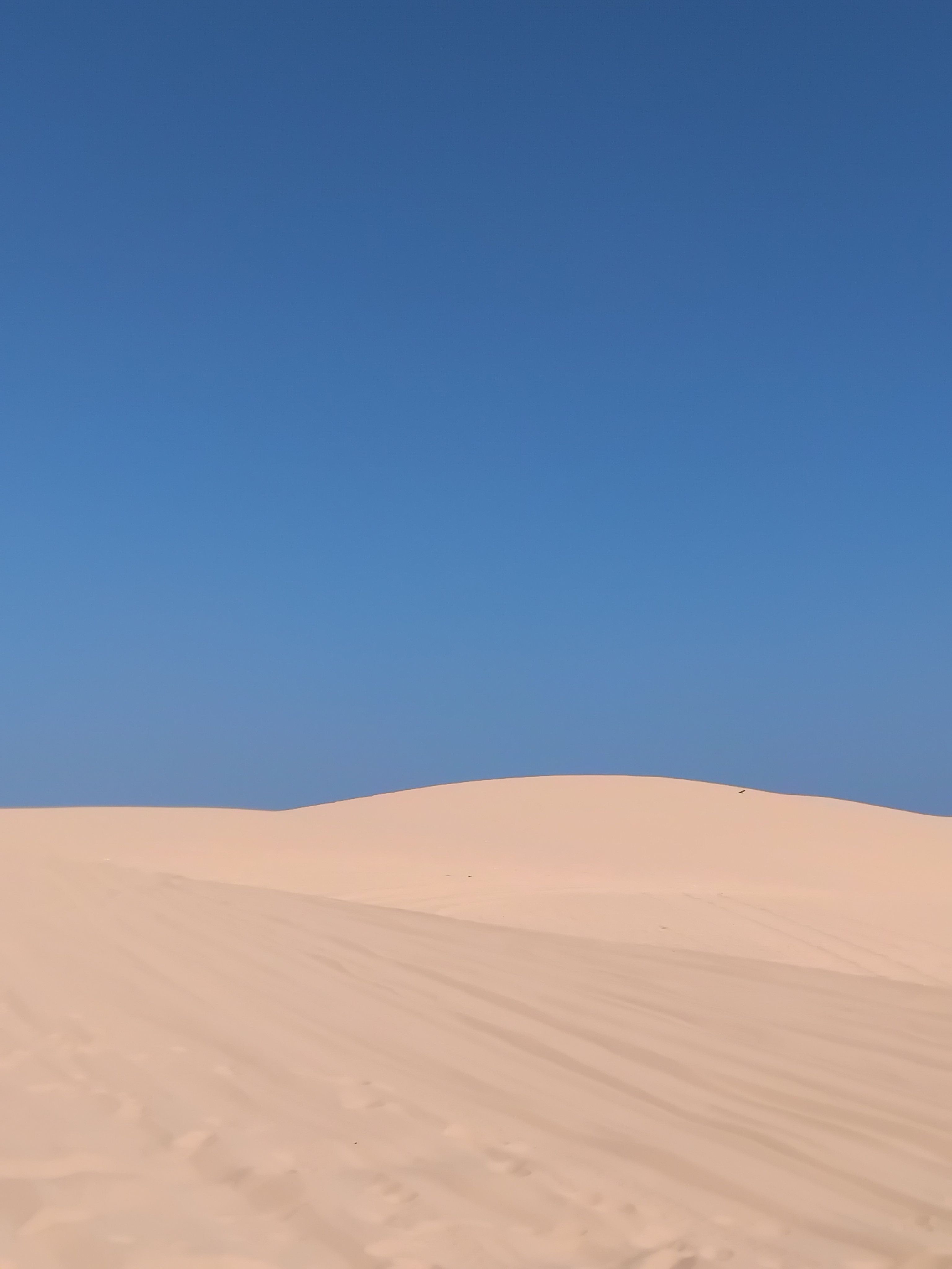 Serene Desert Sand Dunes Under Clear Blue Sky · Free Stock Photo