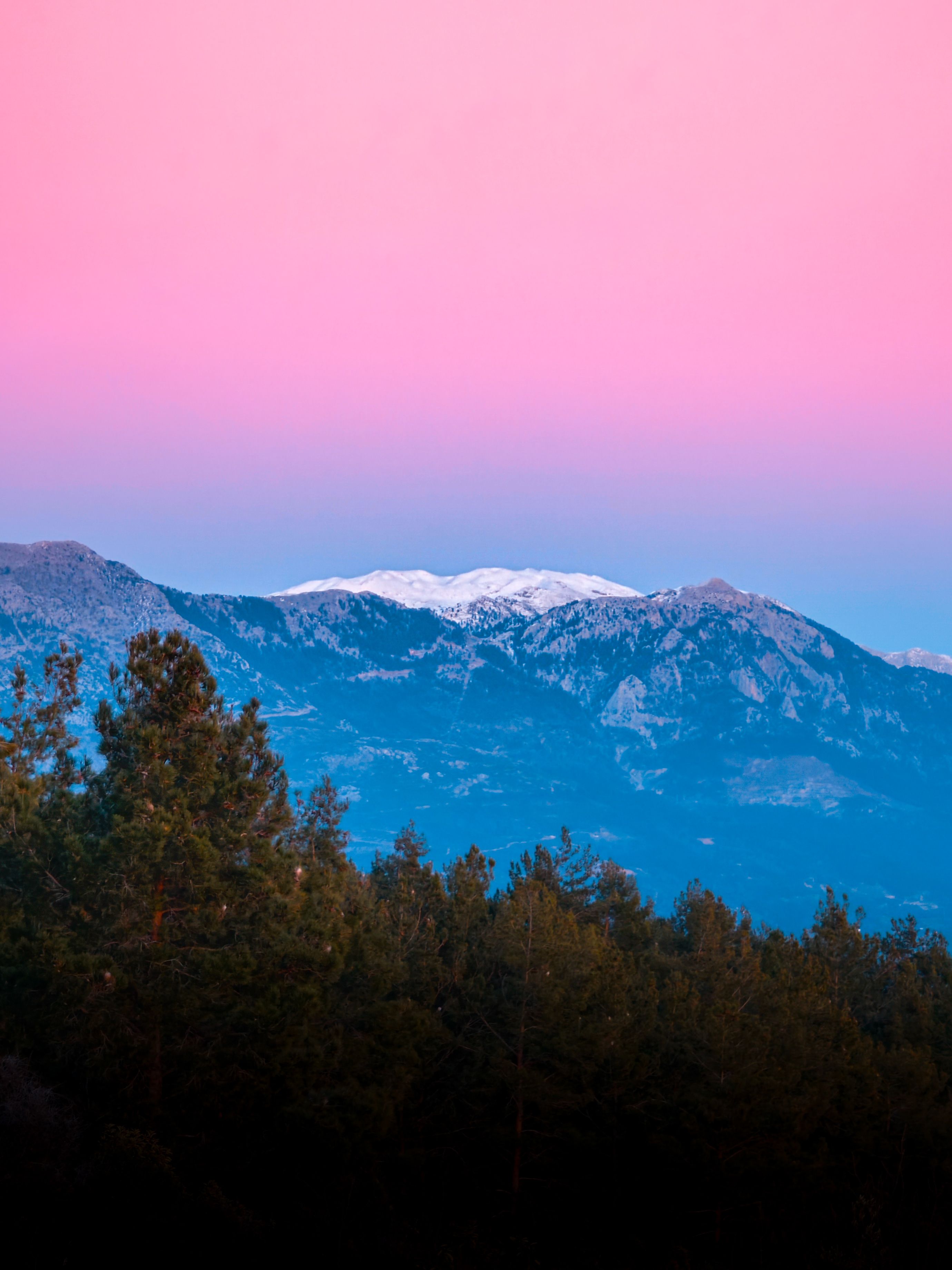 Breathtaking sunset over the Taurus Mountains in Alanya, Antalya, Turkey, showcasing vibrant pink skies.