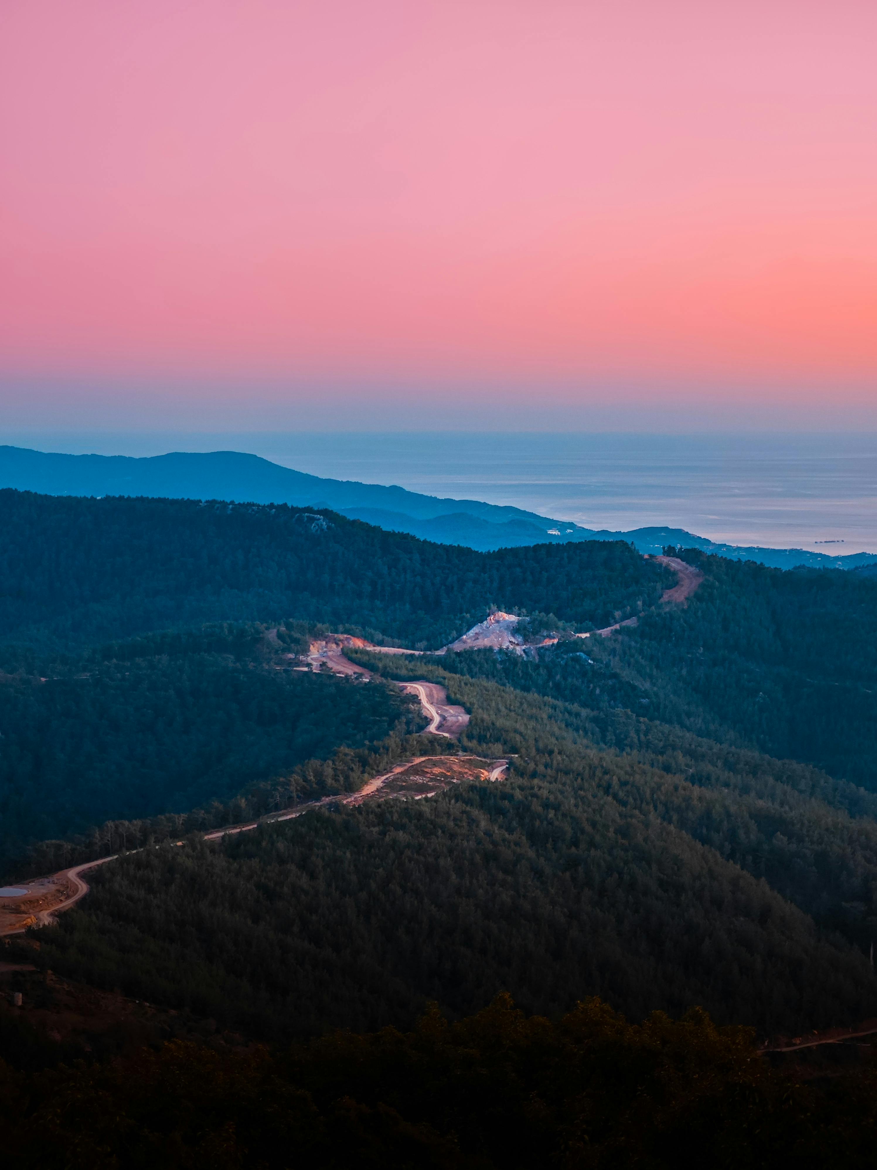 Stunning view of winding roads through lush hills at sunset in Alanya, Antalya, Turkey.