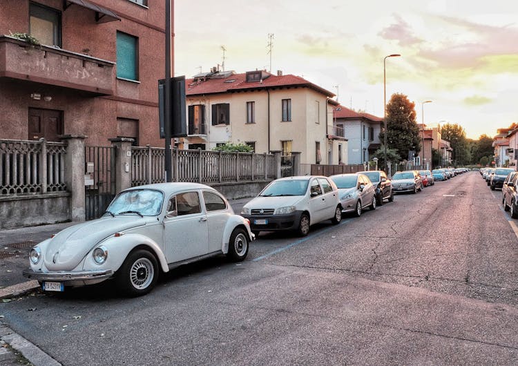 Retro Car On City Street At Sunset