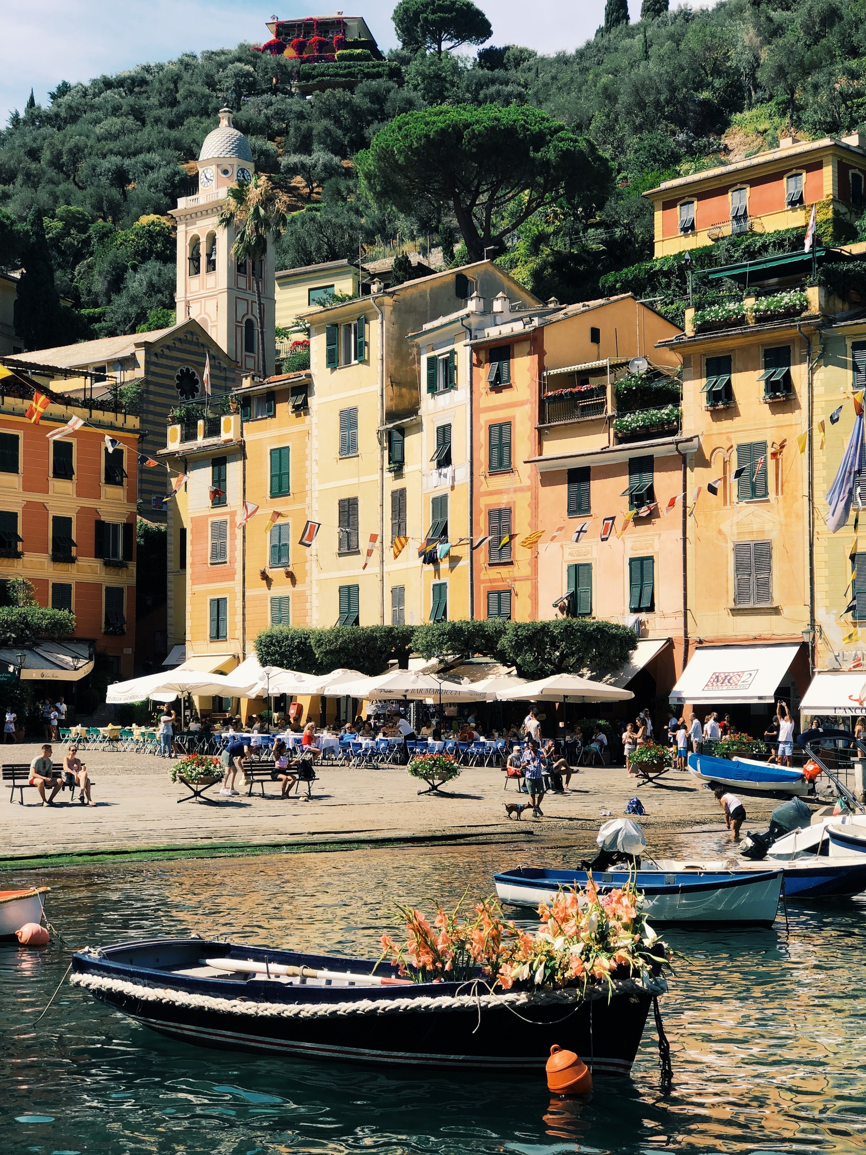 Vibrant waterfront scene in Portofino, Italy, showcasing colorful buildings and boats.