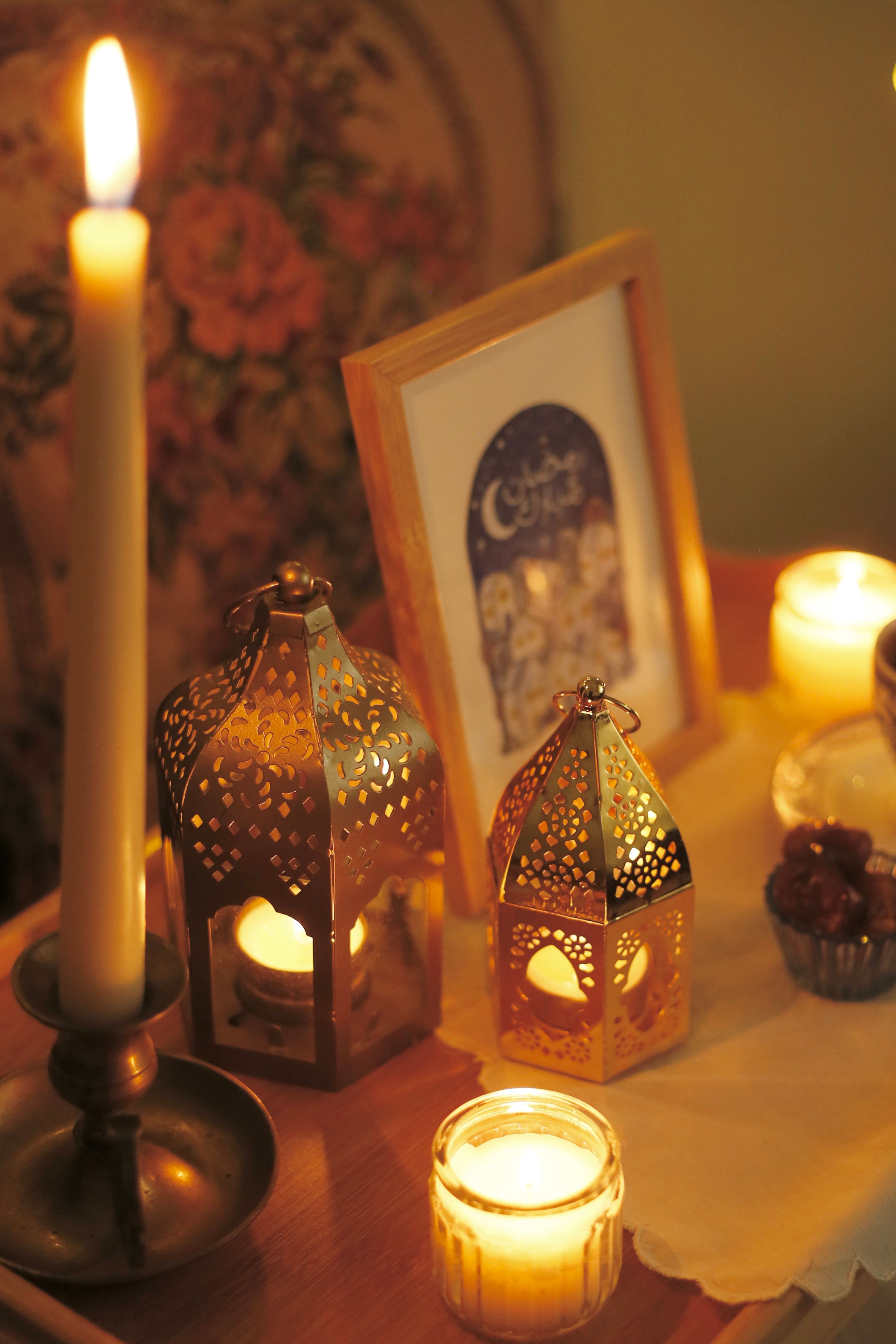 A cozy indoor scene with ornate lanterns and candlelight creating a festive atmosphere.