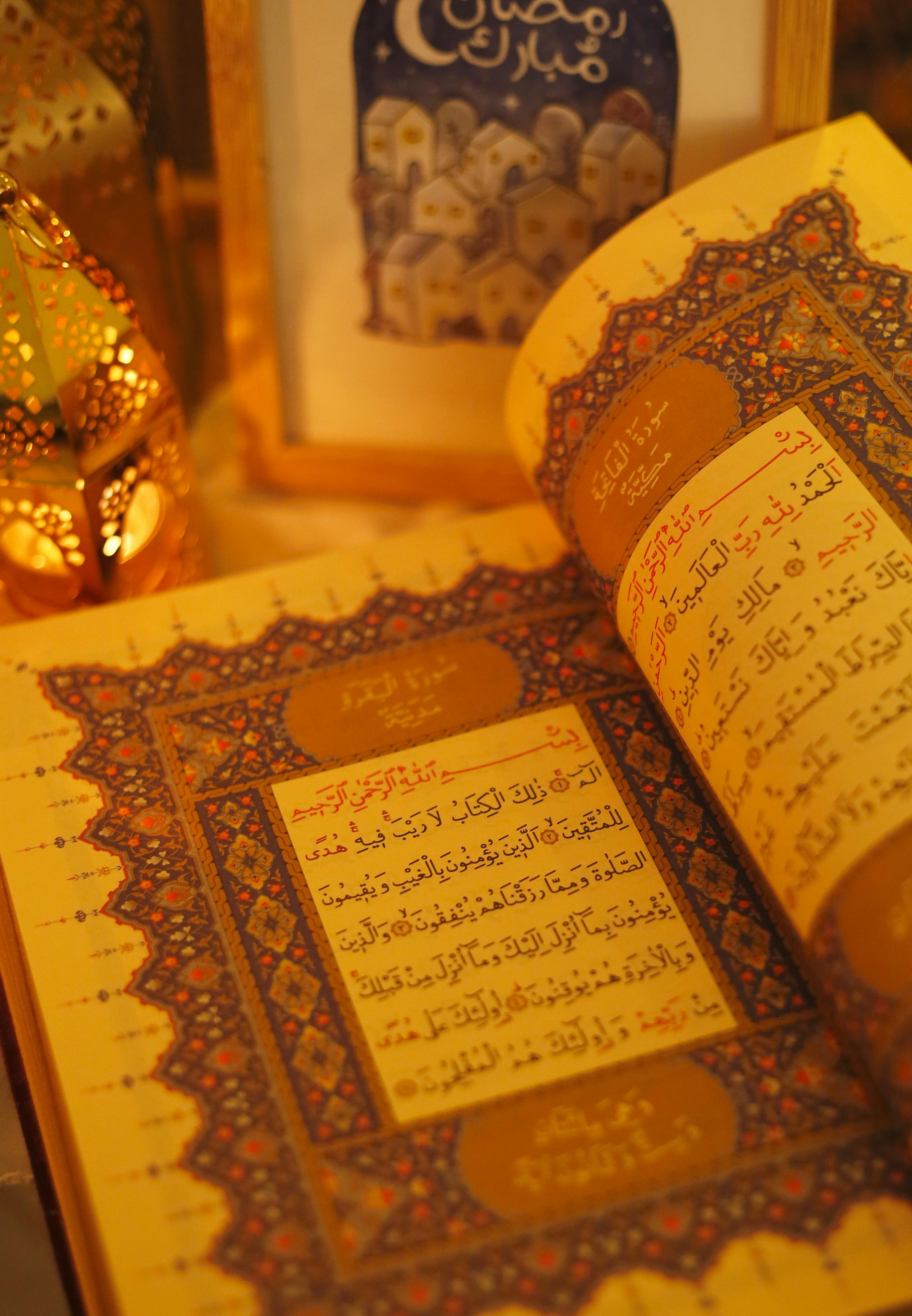An open Quran with intricate designs surrounded by golden lanterns, symbolizing Ramadan spirituality.