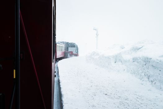 A scenic train journey through a snow-covered winter landscape, evoking a sense of adventure.