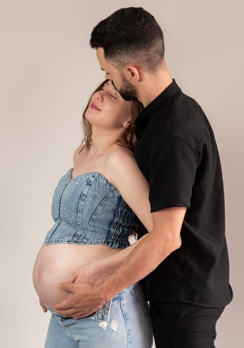 Free Tender moment between a loving couple embracing during pregnancy. Stock Photo