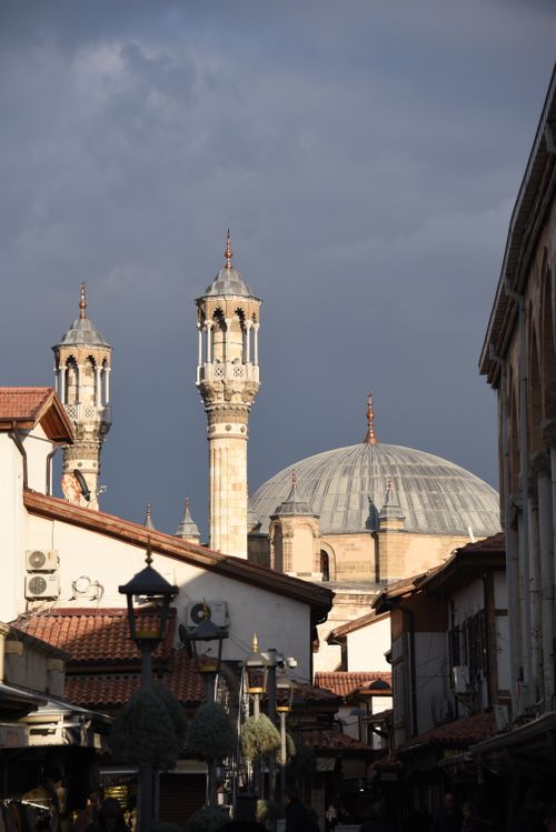 Free Minarets and domed mosque tower over a traditional bazaar street, capturing cultural architecture. Stock Photo