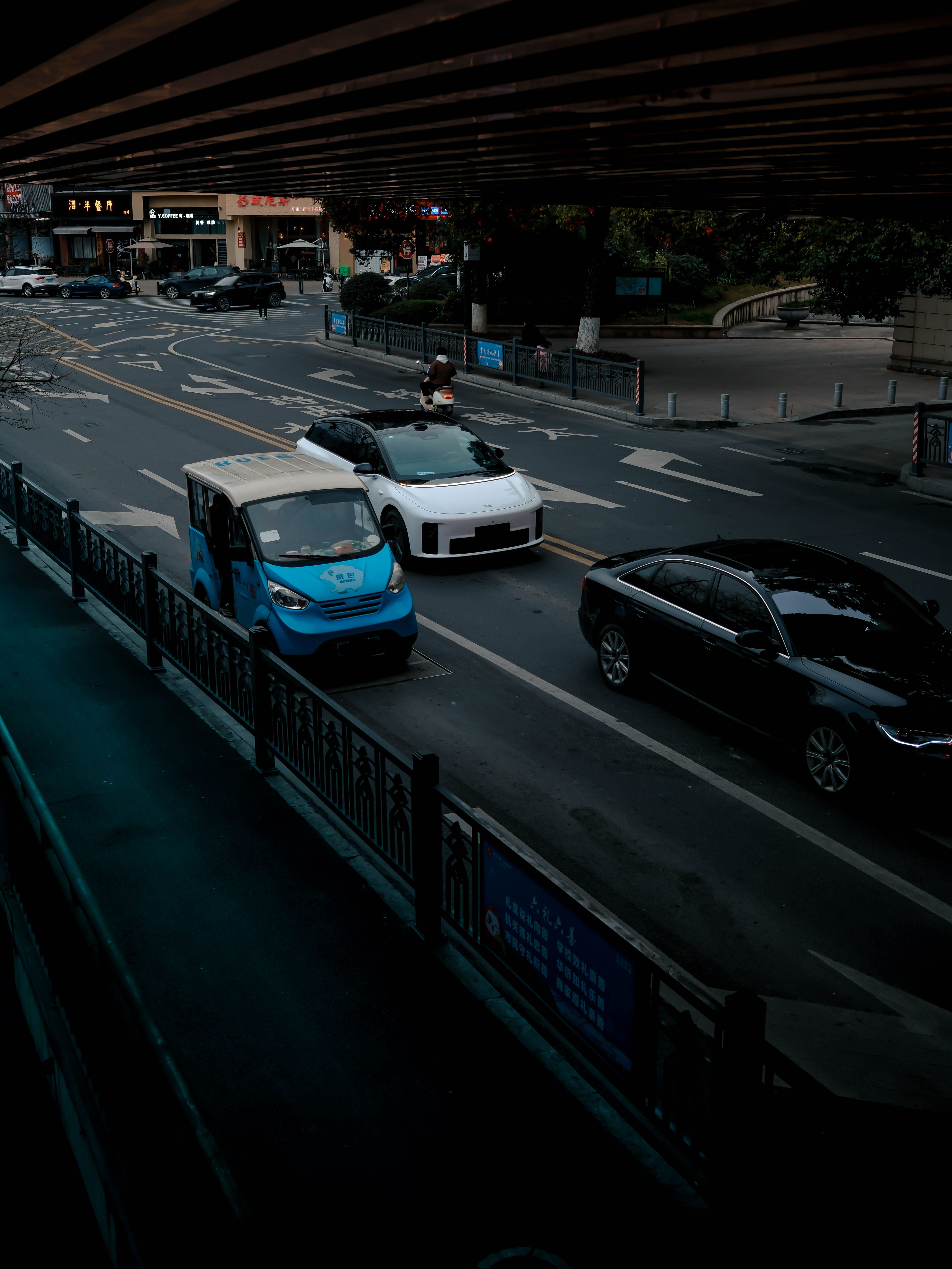 Urban Street View with Vehicles Under Overpass · Free Stock Photo