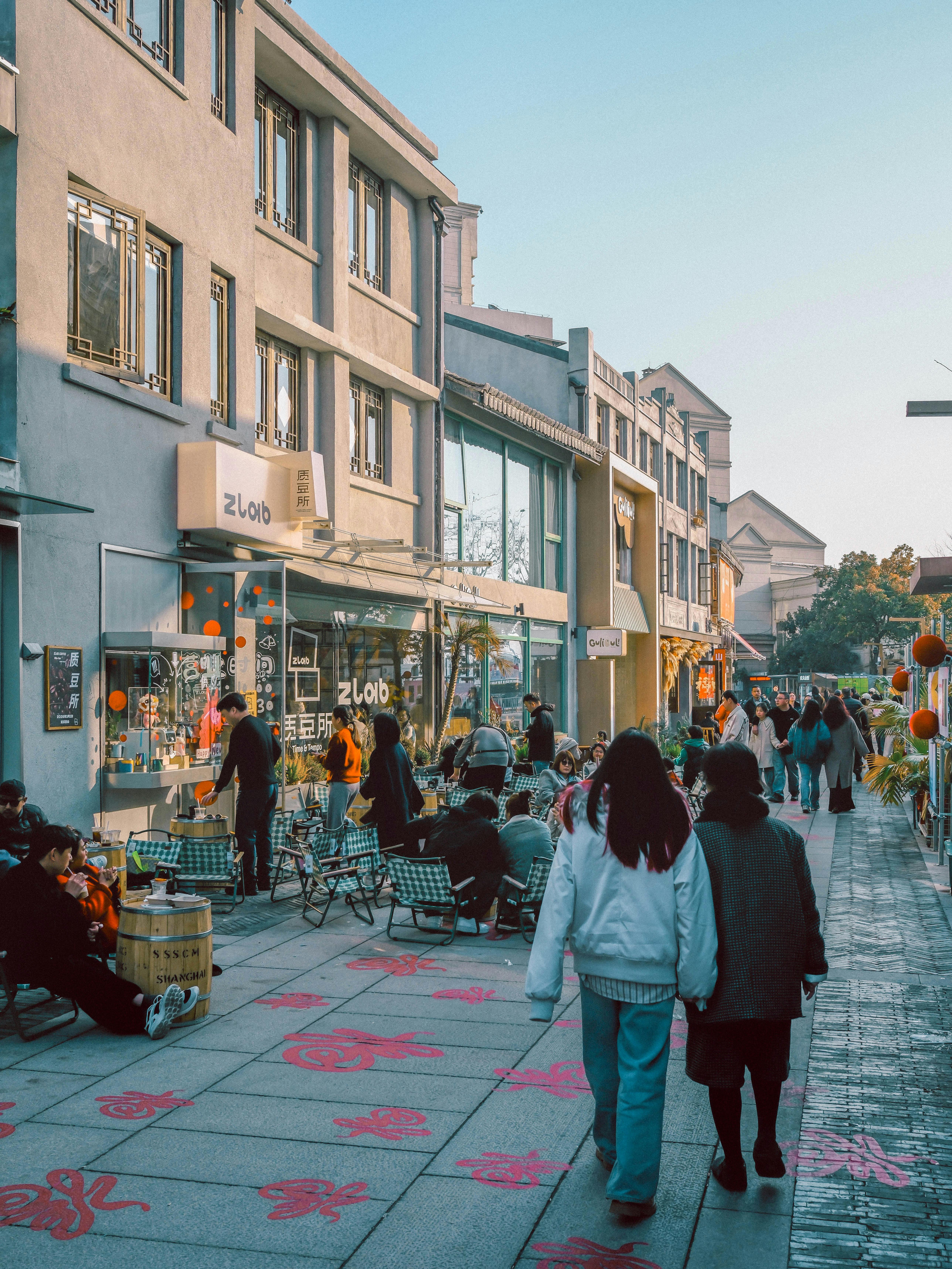 Bustling Urban Street Scene in Early Evening