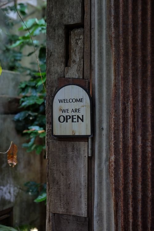 Free Vintage wooden door with an open sign, inviting and rustic. Stock Photo