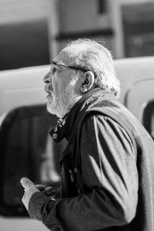 Free Elderly man with beard walking outdoors in black and white. Stock Photo
