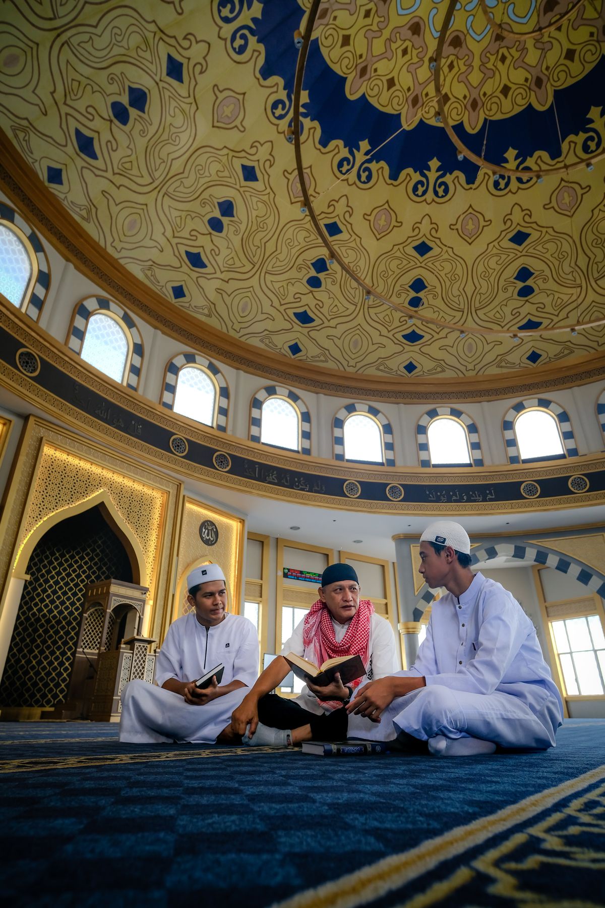 Young Muslims learning together inside a mosque