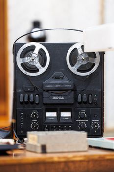 Close-up of a vintage reel-to-reel tape recorder, capturing nostalgia and retro audio technology.