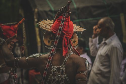 Free Sri Lankan dancer in traditional costume performing a ritual dance outdoors. Stock Photo