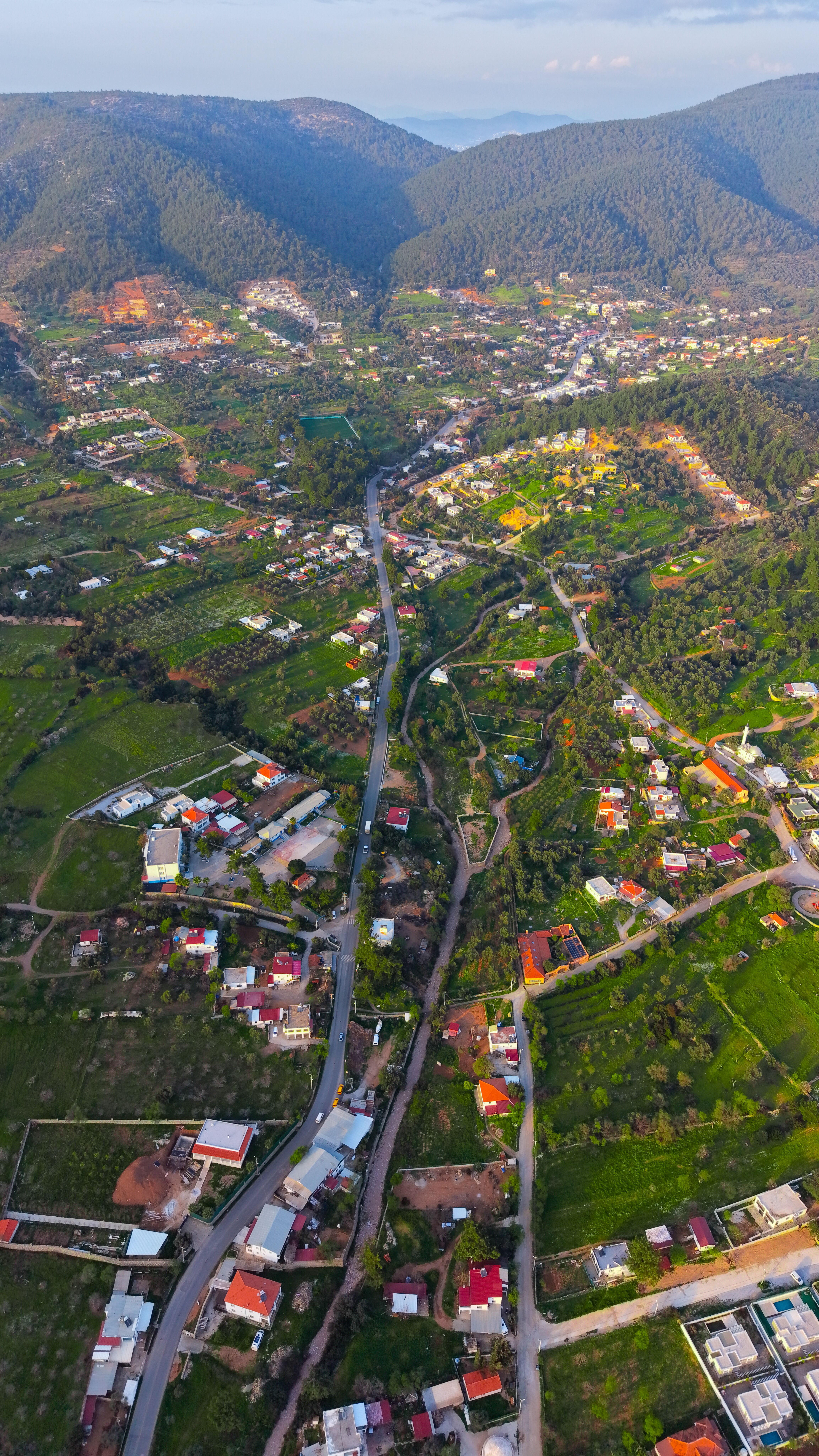 Explore a scenic aerial view of a vibrant village in Bodrum, Türkiye, during a warm spring day.