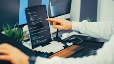 Close-up of Programmer Typing Code on Laptop